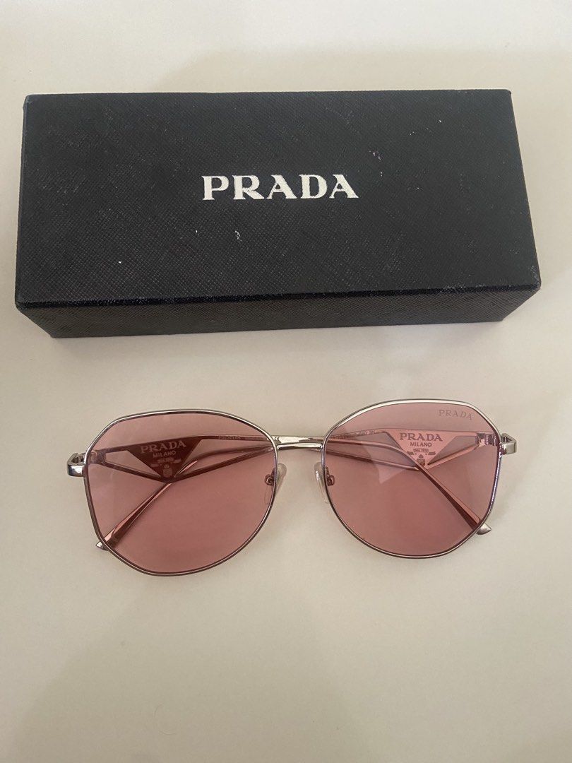 Prada Sunglasses Pink Oval Frame (Category: Sunglasses & Eyewear) located in Bangui. Submitted by loricam (Listing ID 1462054255, Image 2). Description: PRADA Milano Sunglasses ✨ • Like New / Never Used • Rose Gold Frame • Pink/Rose Tinted Lenses • Purchased in USA 🇺🇸 Selling because I wear prescription glasses and don’t get to use them. ❤️ Prada card/certificate was included when purchased but unfortunately got misplaced..