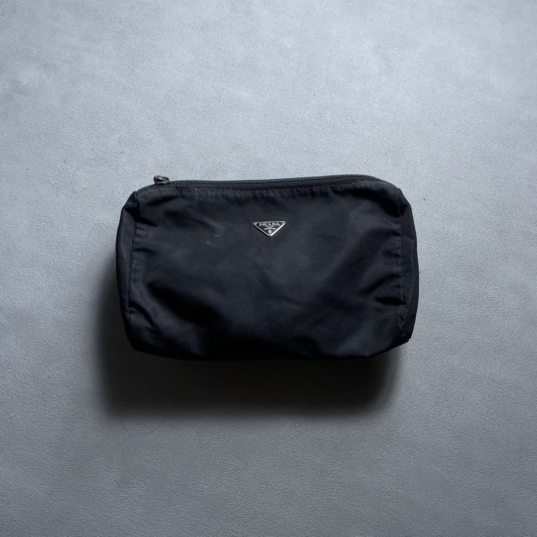 PRADA TESSUTO COSMETIC ZIP POUCH (Category: Clutches) located in Manila. Submitted by revise.ph_ (Listing ID 1462223527, Image 1). Description: PRADA TESSUTO COSMETIC ZIP POUCH Made in Italy Height/Length:5.5 Width:9.8 Side Width:3.8 Issue:Scratch & hole check detailed photo Price: 3,500 Free Shipping Via Jnt.
