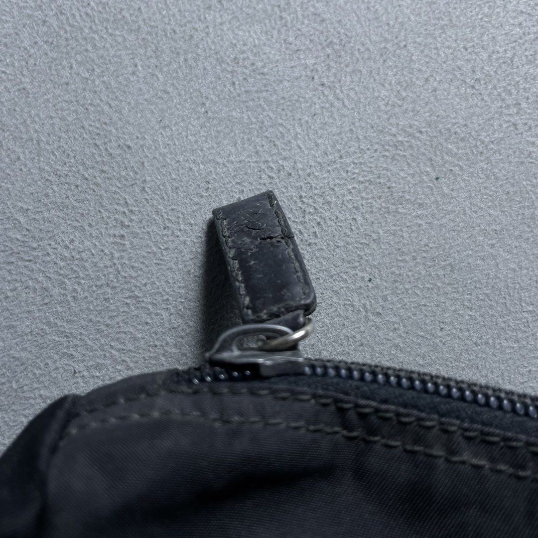PRADA TESSUTO COSMETIC ZIP POUCH (Category: Clutches) located in Manila. Submitted by revise.ph_ (Listing ID 1462223527, Image 3). Description: PRADA TESSUTO COSMETIC ZIP POUCH Made in Italy Height/Length:5.5 Width:9.8 Side Width:3.8 Issue:Scratch & hole check detailed photo Price: 3,500 Free Shipping Via Jnt.