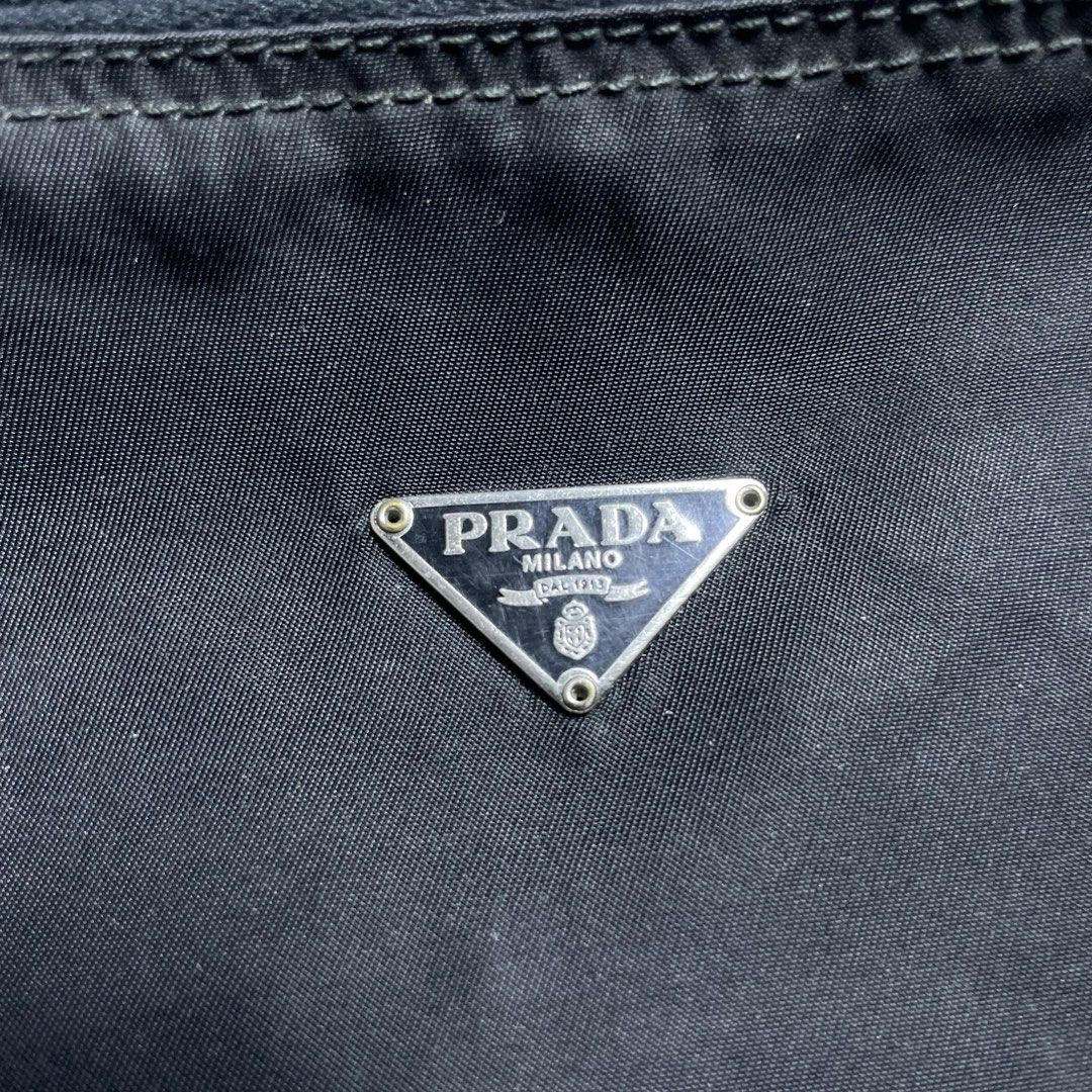 PRADA TESSUTO COSMETIC ZIP POUCH (Category: Clutches) located in Manila. Submitted by revise.ph_ (Listing ID 1462223527, Image 2). Description: PRADA TESSUTO COSMETIC ZIP POUCH Made in Italy Height/Length:5.5 Width:9.8 Side Width:3.8 Issue:Scratch & hole check detailed photo Price: 3,500 Free Shipping Via Jnt.