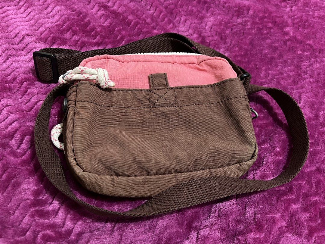 Preloved Authentic Kipling Sisko Small Crossbody Bag (Category: Cross-body Bags) located in Quezon City. Submitted by g0bblyg33kd0m (Listing ID 1462137265, Image 2). Description: 💖 Preloved Authentic Kipling Sisko Small Crossbody Bag 📌 In Valley Duo Pink colorway, featuring a multi-toned pink and cream nylon design with a brown base and adjustable strap 📏 Approximate Size: Width: 7 inches Height: 5 inches 🏷️ PRICE: ₱ 350 📌Guaranteed Authenti