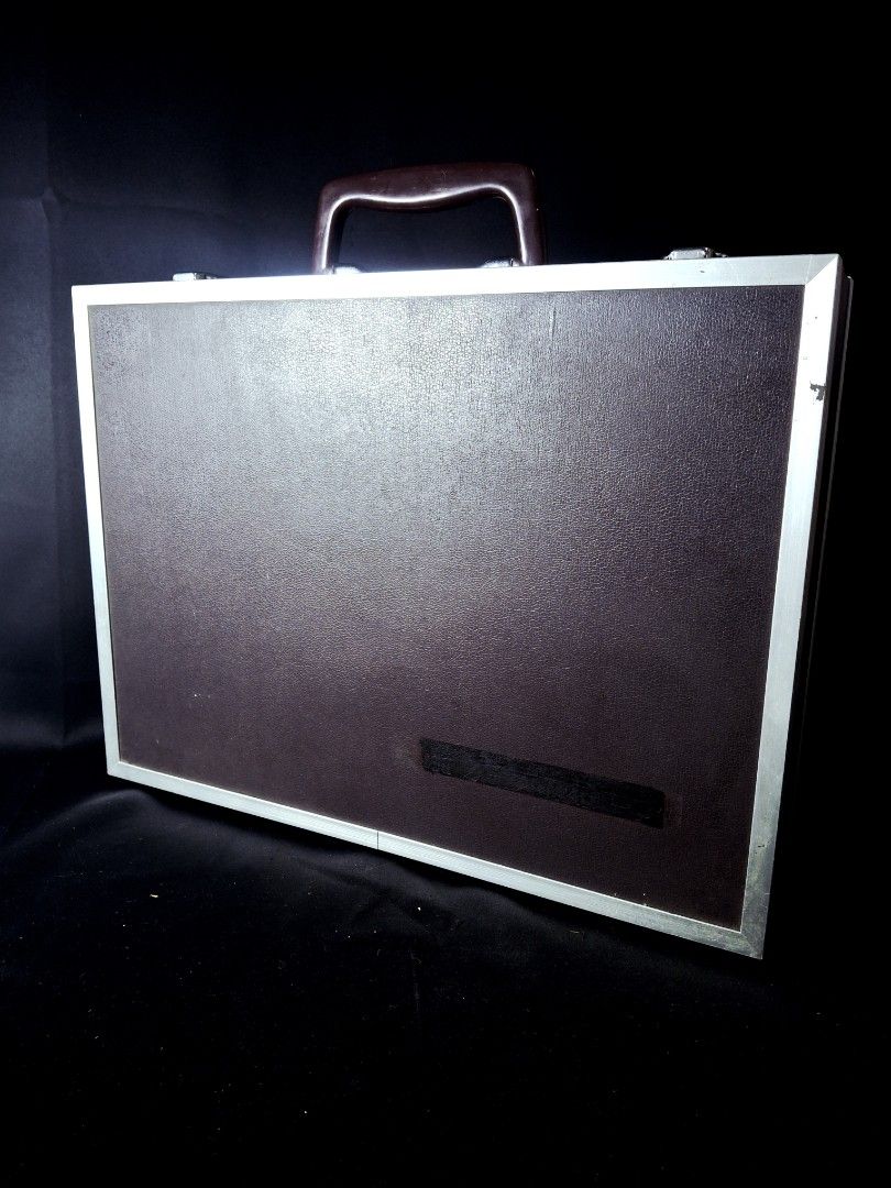 Professional Suit Case with Red Velvet Compartment (Category: Briefcases) located in Calamba. Submitted by saitamaeli41953 (Listing ID 1462184844, Image 3). Description: - Vintage professional briefcase - Dark brown exterior with silver trim - Plush red velvet interior lining - Multiple interior pockets and card slots - Sturdy handle and secure latches - Ideal for business trips or as a prop.