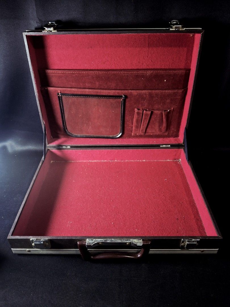 Professional Suit Case with Red Velvet Compartment (Category: Briefcases) located in Calamba. Submitted by saitamaeli41953 (Listing ID 1462184844, Image 2). Description: - Vintage professional briefcase - Dark brown exterior with silver trim - Plush red velvet interior lining - Multiple interior pockets and card slots - Sturdy handle and secure latches - Ideal for business trips or as a prop.