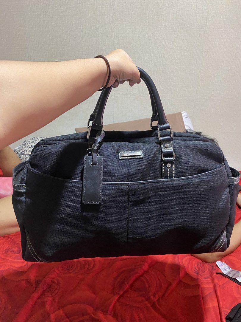 PROGRES Black Canvas Leather Trim Duffle Bag (Category: Sling Bags) located in Manila. Submitted by cdb_22 (Listing ID 1462226642, Image 2). Description: - Black canvas duffle bag - Leather trim - Multiple exterior pockets - Spacious interior with internal pockets - PROGRES logo zippers - Ideal for travel or gym use - Clean interior.