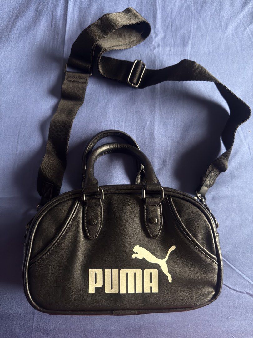 Puma Black Mini Duffle Bag with Strap (Category: Cross-body Bags) located in Pasig City. Submitted by sellers_block (Listing ID 1462100733, Image 1). Description: - Black Puma mini duffle bag - Features top handles - Includes a detachable shoulder strap - Classic Puma logo on the front - Ideal for carrying your essentials - Compact and small size - Sells for 4,500 in store.