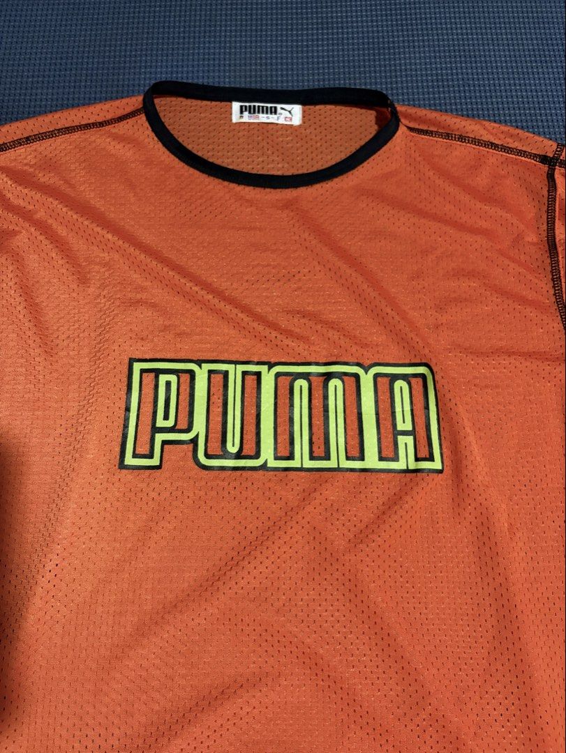 Puma Orange Mesh T-shirt with Logo (Category: Tshirts & Polo Shirts ) located in Iloilo. Submitted by astaaa777 (Listing ID 1462121721, Image 2). Description: 25 length 19 width - Puma orange mesh t-shirt - Features Puma logo across the chest (yellow and green outline) - Black trim around neckline and sleeves - Lightweight and breathable material - Perfect for casual wear or sports.