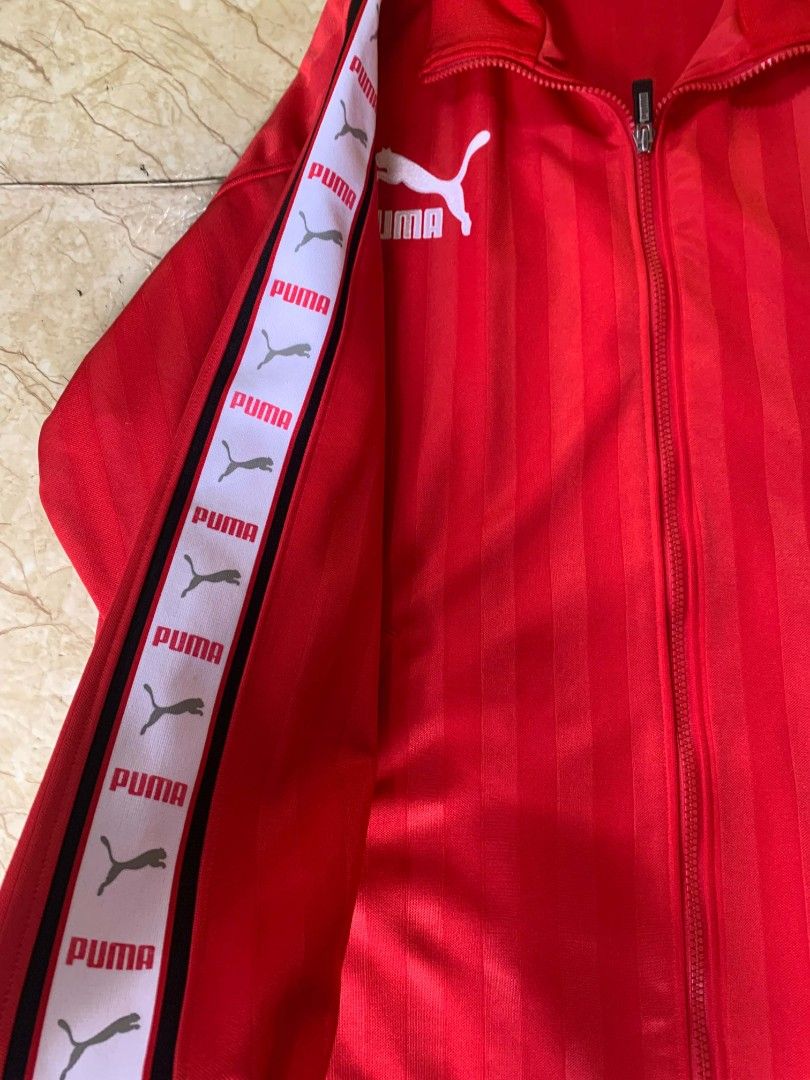 Puma Red Track Jacket (Category: Coats, Jackets and Outerwear) located in Quezon City. Submitted by chic.on.a.dime (Listing ID 1462069339, Image 2). Description: - NO ISSUE (MY PERSONAL JACKET, NOT UKAY) - WALANG BASAG PRINTS, LAHAT, AS IN, BAGONG BAGO - vintage Puma side-tape track jacket - Iconic Puma logo on chest and large logo on back - Striped detailing on sleeves with Puma branding - Full zip closure - Two front pockets - Ideal for casual 