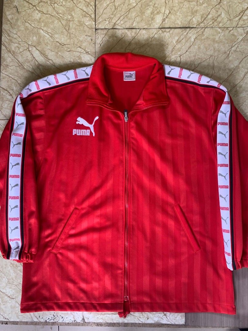 Puma Red Track Jacket (Category: Coats, Jackets and Outerwear) located in Quezon City. Submitted by chic.on.a.dime (Listing ID 1462069339, Image 1). Description: - NO ISSUE (MY PERSONAL JACKET, NOT UKAY) - WALANG BASAG PRINTS, LAHAT, AS IN, BAGONG BAGO - vintage Puma side-tape track jacket - Iconic Puma logo on chest and large logo on back - Striped detailing on sleeves with Puma branding - Full zip closure - Two front pockets - Ideal for casual 