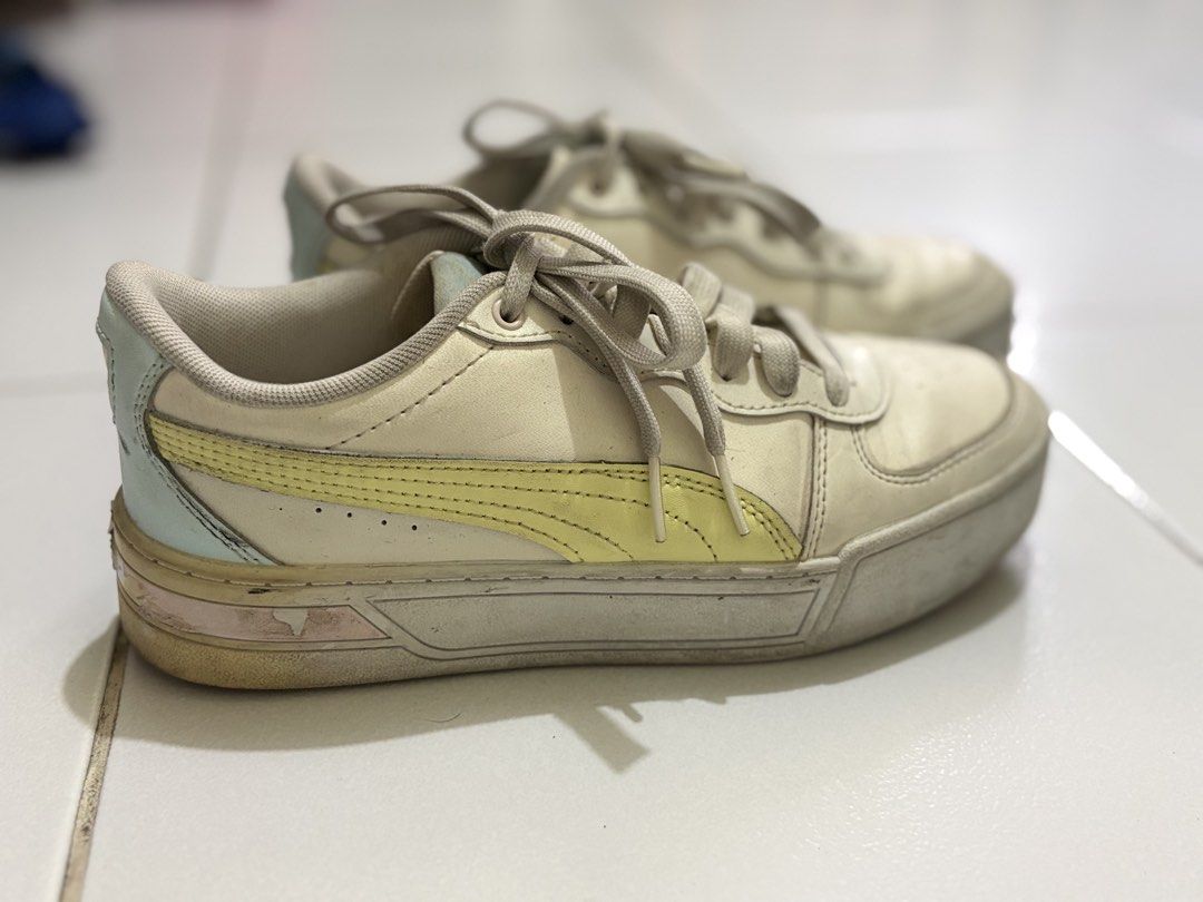 Puma White & Yellow Sneakers (Category: Sneakers) located in Manila. Submitted by angel05012025 (Listing ID 1462125620, Image 2). Description: - White Puma low-top sneakers - Features yellow and light blue accents - Includes laces - Shows some signs of wear on soles and uppers - Perfect for casual everyday wear - NEEDS CLEANING - UK 4 | US 6.5 | 23CM.