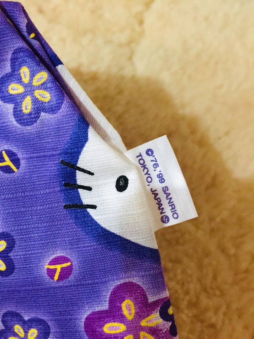 Purple Hello Kitty Floral Pouch (Category: Purses & Pouches) located in Baguio. Submitted by izza_thrifty (Listing ID 1462063755, Image 2). Description: - Adorable purple pouch featuring a charming Kitty and floral print. - Secure zipper closure to keep your belongings safe. - Compact size, perfect for coins, small makeup, or other essentials. - Authentically made in Japan. - A must-have accessory for any Kitty enthusiast!.