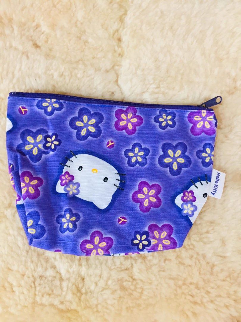 Purple Hello Kitty Floral Pouch (Category: Purses & Pouches) located in Baguio. Submitted by izza_thrifty (Listing ID 1462063755, Image 1). Description: - Adorable purple pouch featuring a charming Kitty and floral print. - Secure zipper closure to keep your belongings safe. - Compact size, perfect for coins, small makeup, or other essentials. - Authentically made in Japan. - A must-have accessory for any Kitty enthusiast!.