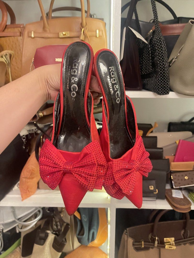 Rag & Co Red Bow Heels (Category: Heels) located in Marilao. Submitted by wardrovearchives (Listing ID 1462204390, Image 1). Description: - Brand: Rag & Co. - Color: Red - Style: Pointed toe, slip-on heels - Features: Sparkly bows on the front - Heel Height: Comfortable - Occasion: Great for dressing up any outfit.