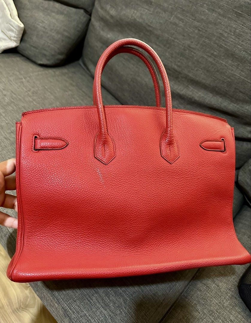 Red Leather Top Handle Bag (Category: Luxury Bags & Wallets) located in Manila. Submitted by luxuryjuly (Listing ID 1462045025, Image 1). Description: - Classic red leather handbag - Textured finish - Top handles - Structured shape - Metal hardware details - Spacious interior - Versatile for daily use or special occasions - Timeless piece.