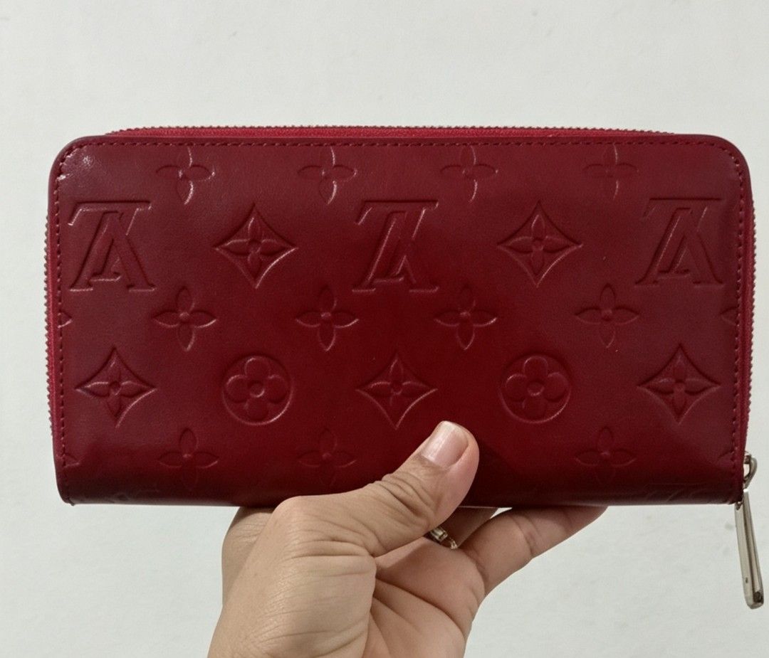 Red Long Wallet (Category: Wallets & Card holders) located in Tarlac. Submitted by faithfulfinds (Listing ID 1462261093, Image 1). Description: Red Vernis Zip-Around Long Wallet (Japan source) Red glossy long wallet featuring a embossed monogram pattern. -Very spacious and holds plenty of cards and cash. Condition: Almost like new, minimal signs of use. -Makapal ang material. Zipper: Runs perfectly smooth. Note: NOT AUTH.