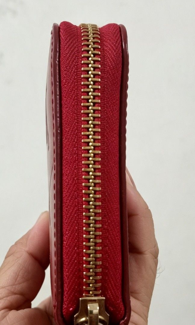 Red Long Wallet (Category: Wallets & Card holders) located in Tarlac. Submitted by faithfulfinds (Listing ID 1462261093, Image 3). Description: Red Vernis Zip-Around Long Wallet (Japan source) Red glossy long wallet featuring a embossed monogram pattern. -Very spacious and holds plenty of cards and cash. Condition: Almost like new, minimal signs of use. -Makapal ang material. Zipper: Runs perfectly smooth. Note: NOT AUTH.