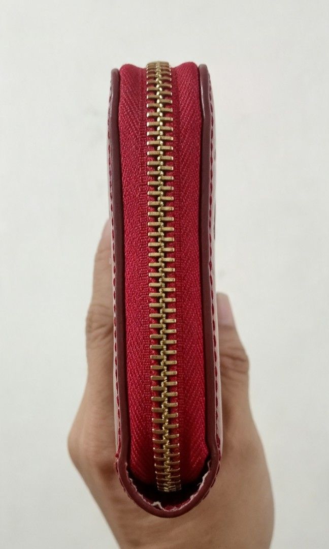 Red Long Wallet (Category: Wallets & Card holders) located in Tarlac. Submitted by faithfulfinds (Listing ID 1462261093, Image 2). Description: Red Vernis Zip-Around Long Wallet (Japan source) Red glossy long wallet featuring a embossed monogram pattern. -Very spacious and holds plenty of cards and cash. Condition: Almost like new, minimal signs of use. -Makapal ang material. Zipper: Runs perfectly smooth. Note: NOT AUTH.