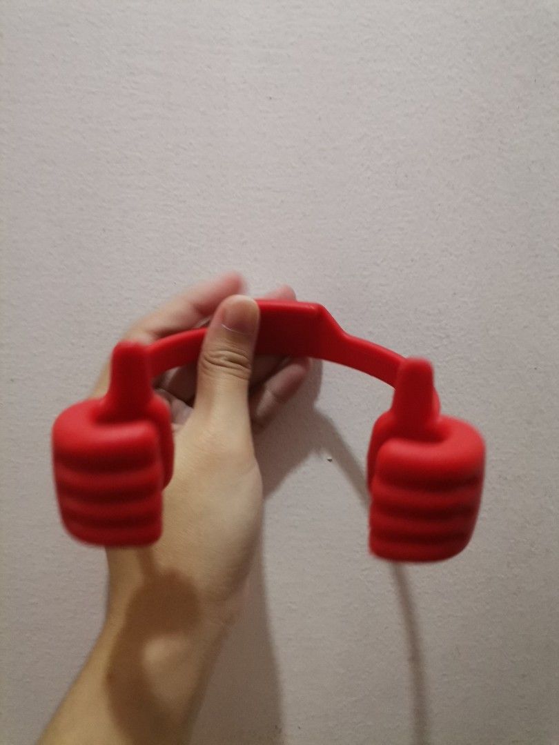 Red "Thumbs Up" Phone Holder Stand (Category: Mounts & Holders) located in Makati City. Submitted by kookybearsstuff (Listing ID 1462114524, Image 1). Description: - Fun red phone holder shaped like a thumbs-up! - Arms securely grip your phone. - Ideal for hands-free viewing on desks or tables. - Perfect for watching videos or making video calls. - Easy to use and portable design..