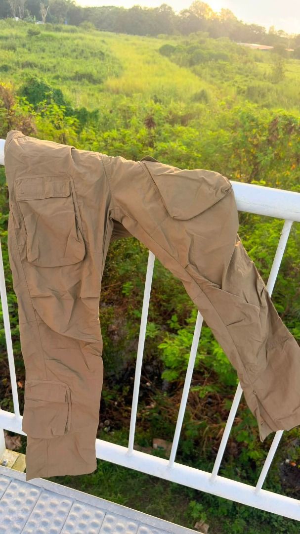 Richie Le Cargo Pants (Category: Trousers) located in Angeles City. Submitted by keedriae (Listing ID 1462174707, Image 2). Description: - Relaxed fit brown cargo pants - Multiple pockets on front and sides - Adjustable drawstring waist for comfort - Ankle zippers for customizable fit - Versatile for casual wear and outdoor activities - Easy to style with any top.