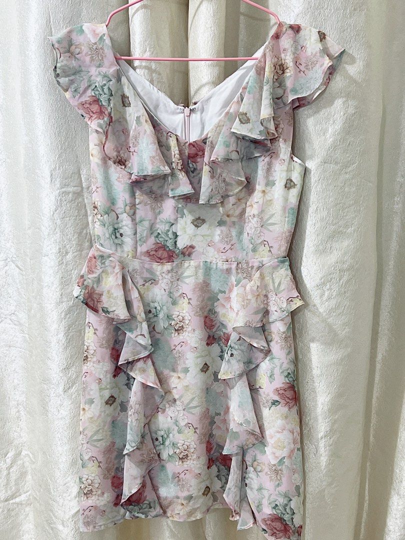 Romantic Botanical Mini light flowy bias dress (Category: Dresses) located in Cavite. Submitted by wishie_collects (Listing ID 1462237146, Image 2). Description: Style & Design: It is a romantic, pastel floral-print mini dress featuring a flattering V-neckline with playful ruffled cap sleeves. Details: The dress is highlighted by cascading ruffles that run along the neckline and down the front of the skirt for a soft, whimsical touch. Pattern & F