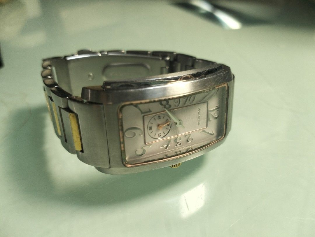 ROMIA Rectangular Watch with Subdial (Category: Women's Watches) located in General Mariano Alvarez. Submitted by ma.miafajardo1219 (Listing ID 1462052446, Image 2). Description: - ROMIA rectangular watch - White dial with seconds subdial - Silver and gold tone metal bracelet - Water resistant - Unique number styling on dial - Ideal for everyday wear.