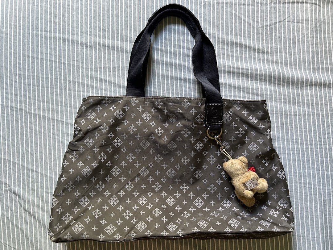 Russet Tote Bag (Category: Tote Bags) located in Bambang. Submitted by mythriftstyle (Listing ID 1462067506, Image 1). Description: - Russet tote bag Large size - free cute bear charm - Grey color with a subtle all-over pattern - Secure zipper closure at the top - Interior features a brown lining - Two convenient snap buttons on the sides - Durable black nylon handles - Ideal for everyday use, travel, office and diaper bag.