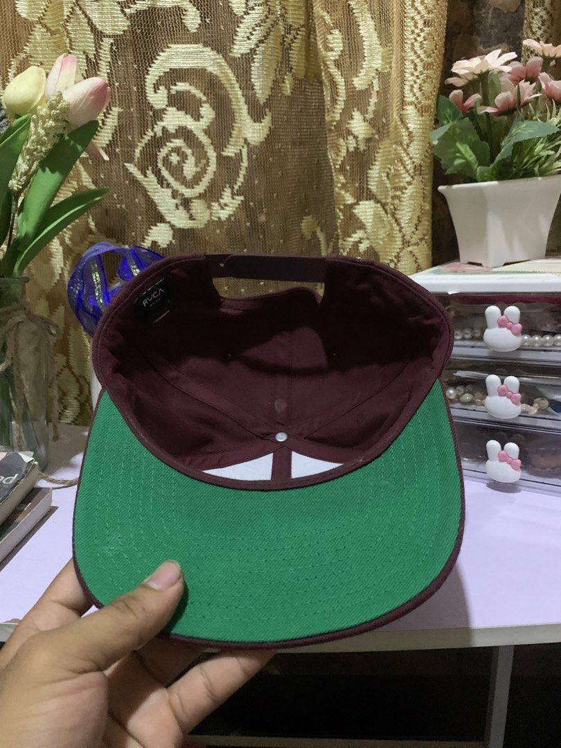 RVCA Snapback Cap Burgundy Green Underbrim (Category: Caps & Hats) located in Quezon. Submitted by ken2x_thrift (Listing ID 1462081466, Image 2). Description: - Classic RVCA snapback hat - Burgundy color with green underbrim - Simple and clean design - Adjustable strap for a custom fit - Perfect for everyday wear.