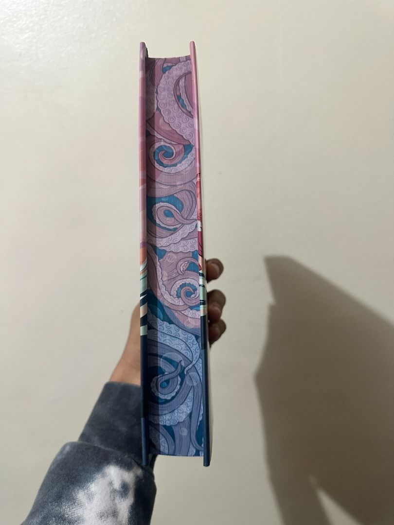 Saltswept Illumicrate Edition (Category: Storybooks) located in Pasay City. Submitted by library_hecate (Listing ID 1462155463, Image 2). Description: • Exclusive Redesigned Cover: Features exclusive cover art designed by @stephcuff_creative with art from @alterlier. • Hardcase Design: Full-color artwork on the hardback book case with foil details by @artofmaxinevee. • Digitally Printed Edges: Custom sprayed and digitally printed edges on all thr