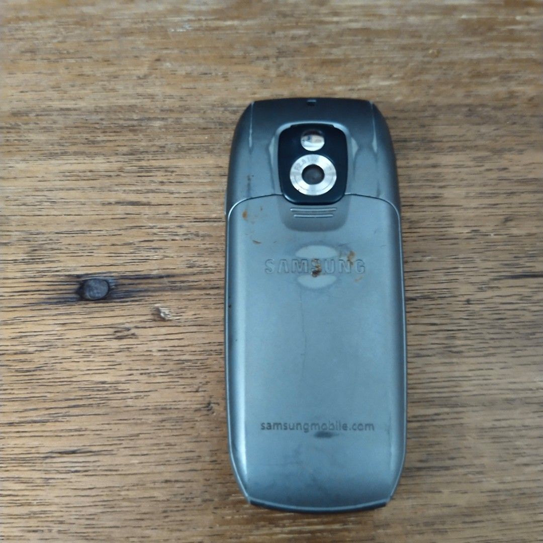 Samsung Basic Feature Phone (Category: Early Generation Mobile Phones) located in Singapore. Submitted by woof777 (Listing ID 1462077813, Image 2). Description: - Samsung basic phone - Simple and easy to use - Features a rear camera - Ideal for calls and text messages - Typically offers long battery life - Some cosmetic wear on casing - Fully functional - No charger .