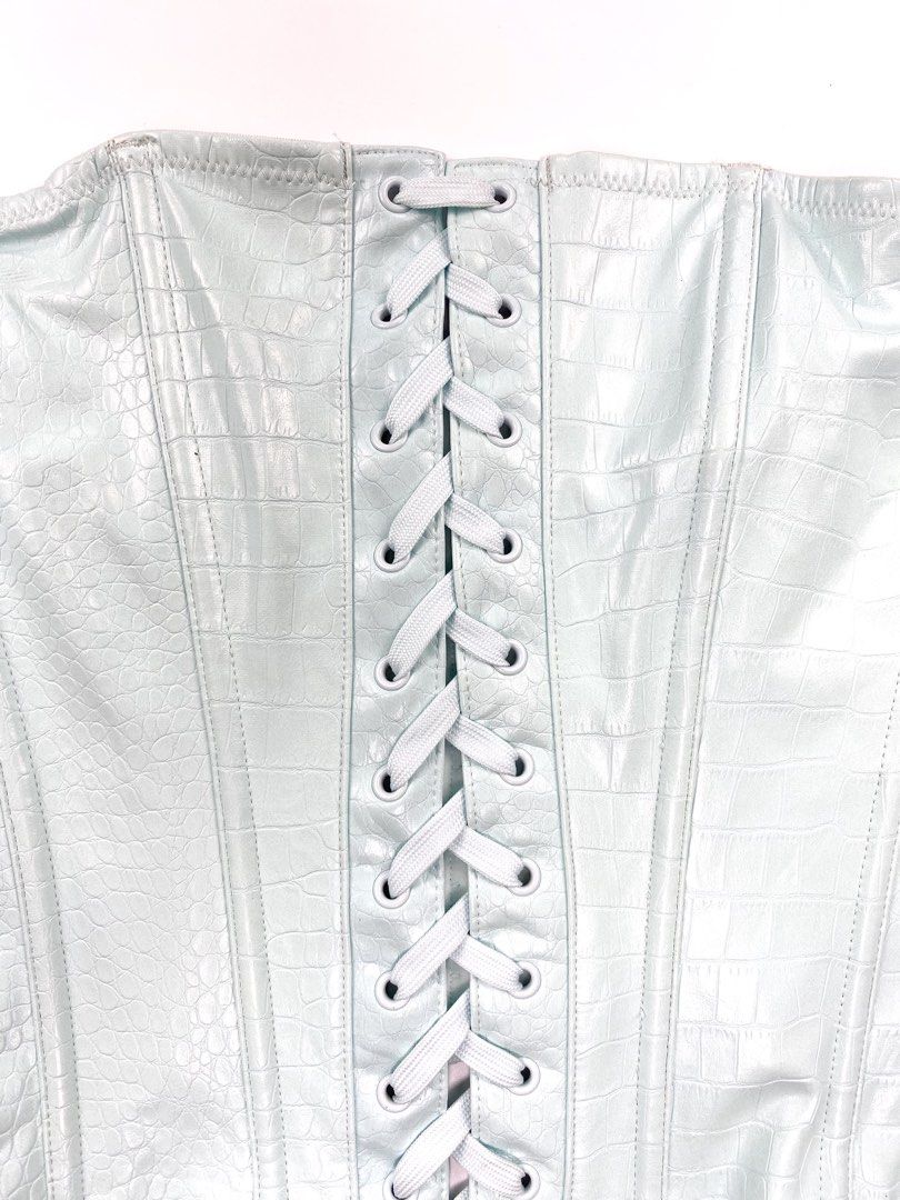 Savage X Ice Blue Croc Leather Corset (Category: Others Tops) located in Angeles City. Submitted by fruits.ph (Listing ID 1462134839, Image 3). Description: Measurements B:13.5”-15” W:11”-12.5” L:13.5” Size on Tag: ❌ Best Fit: S-M *Flat lay measurements* Mannequin Size: M (34”; 25”) Color Rate: 8/10 Flaws: light stain, barely noticeable ( See photos attached) Fabric Type: Synthetic Croc Skin/ Stretchable Fabric ***Color may vary due to lighting. 