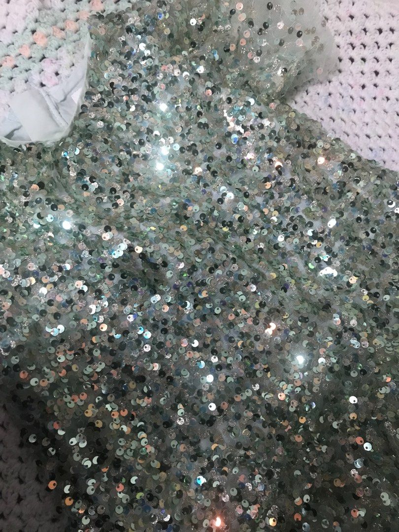 Seed Heritage Sequin Dress Size 4 (Category: Babies & Kids Fashion) located in Caloocan City. Submitted by julie_shooooopppp (Listing ID 1462176016, Image 3). Description: - Sparkly sequin dress - Brand: Seed Heritage - Color: Light blue/mint green - Size: 4 - Features: Short sleeves, ruffled hem - Perfect for parties and special occasions.