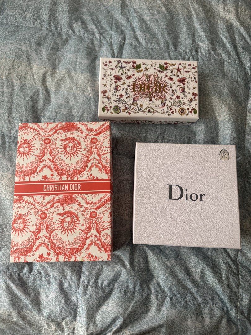 Set of 3 Christian Dior Boxes (Category: Luxury Accessories) located in Manila. Submitted by prelovedshop0818 (Listing ID 1462103865, Image 1). Description: - Set of 3 authentic Christian Dior gift boxes. - Includes one white textured box with 'Dior' logo. - One white box with intricate floral and coral design. - One red and white toile de jouy patterned box with 'Christian Dior' band. - Ideal for storing small valuables or as a collector's item.