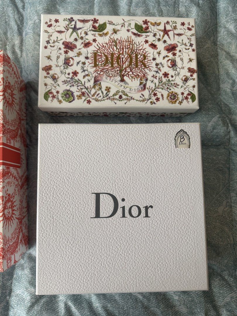 Set of 3 Christian Dior Boxes (Category: Luxury Accessories) located in Manila. Submitted by prelovedshop0818 (Listing ID 1462103865, Image 3). Description: - Set of 3 authentic Christian Dior gift boxes. - Includes one white textured box with 'Dior' logo. - One white box with intricate floral and coral design. - One red and white toile de jouy patterned box with 'Christian Dior' band. - Ideal for storing small valuables or as a collector's item.