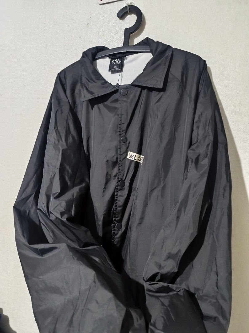 Shaka Black Coach Jacket (Category: Coats, Jackets and Outerwear) located in Pasay City. Submitted by tananoy0508061 (Listing ID 1462068478, Image 2). Description: - Black Shaka Coach Jacket - Size: 2XL - Features: Button-up front, collar, elasticated cuffs, drawstring hem - Style: Simple, classic, great for layering - Occasion: Perfect for casual wear.