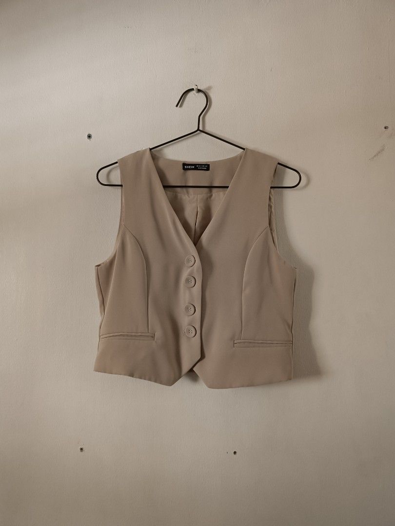 SHEIN Beige Button-Up Sleeveless Vest (Category: Sleeveless) located in Manila. Submitted by shajanina.14 (Listing ID 1462126759, Image 1). Description: SHEIN Preloved As good as new Extra Small- US As per measuring tape, Bust- up to 34 inches Waist- up to 32 inches Length- 18 inches.