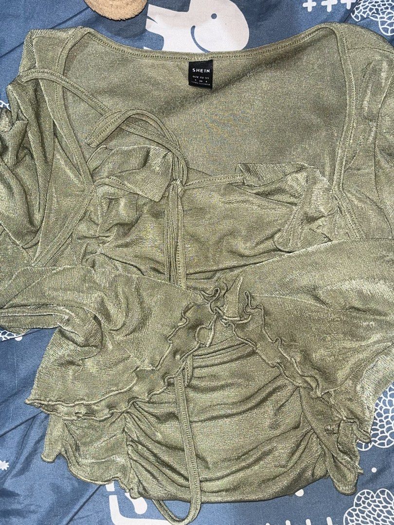 SHEIN tie back lettuce sleeve (Category: Others Tops) located in Quezon City. Submitted by akikekoku (Listing ID 1462194468, Image 2). Description: - Army green crop top from SHEIN - Features a ruched front and elegant bell sleeves - Halter neck with tie-back closure - Fabric has a subtle shimmer - Small on tag #SHEIN #Ruched #Lettuce #Partyfit.