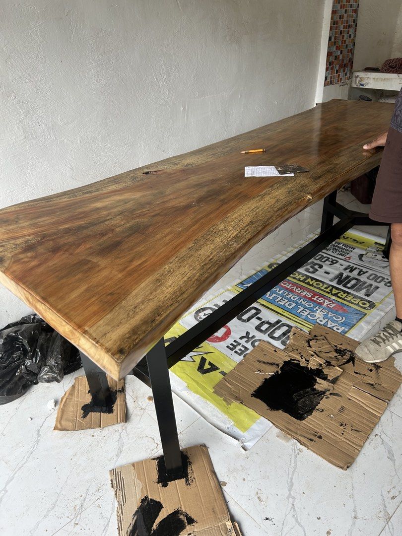 Solid Wood Table with Black Metal Legs (Category: Tables & Sets) located in Bulacan. Submitted by peach1025 (Listing ID 1462090316, Image 3). Description: - Beautiful solid NARRA wood table with natural grain finish - Unique live edge design - Sturdy black metal legs - Versatile: great for dining or as a workspace - Dimensions: Approx. [insert length] x [insert width] x [insert height].