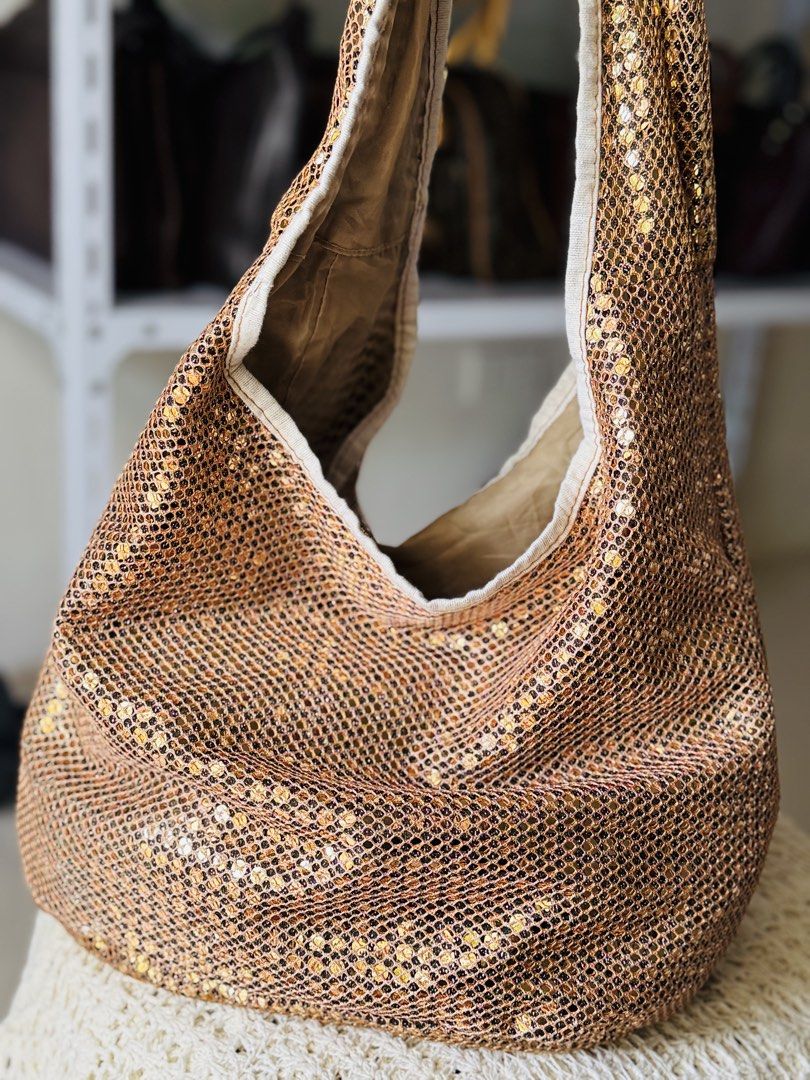 Sparkly Gold Sequin Hobo Bag (Category: Shoulder Bags) located in Bacolod City. Submitted by vintage_vogue6100 (Listing ID 1462139324, Image 1). Description: - Eye-catching gold sequins with a chic mesh overlay - Versatile hobo bag style - Neutral interior lining - Convenient interior zippered pocket and slip pocket - Adds instant glamour to any outfit, day or night.