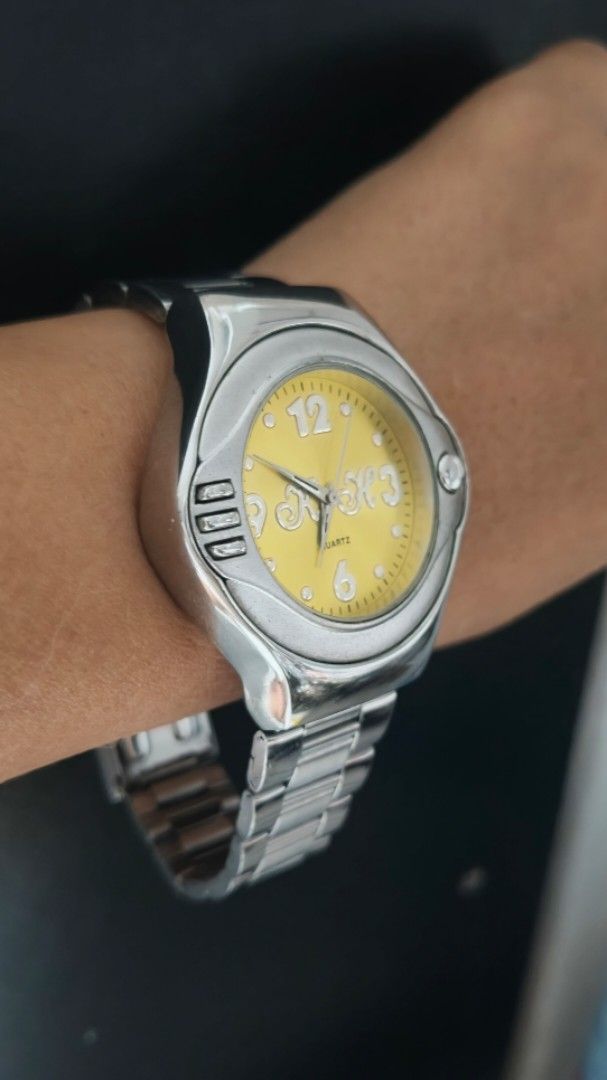 Sport Quartz Watch Yellow Dial (Category: Men's Watches) located in Taguig. Submitted by mercyeugen28914 (Listing ID 1462134142, Image 2). Description: - Silver tone metal watch - Vibrant yellow dial - Reliable quartz movement - Matching silver tone metal band - Clasp engraved with 'SPORT' - Minor signs of wear on the band - Ideal for everyday wear.
