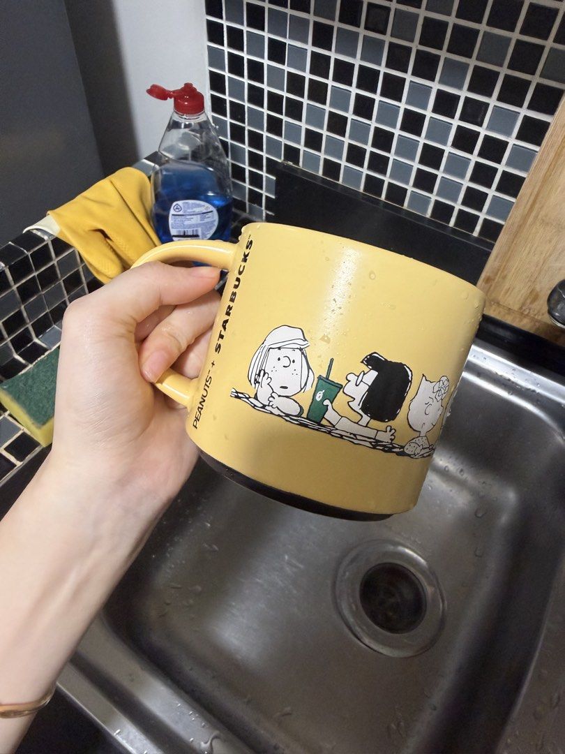Starbucks Peanuts Collaboration Yellow Mug (Category: Coffee & Tea Tableware) located in Manila. Submitted by treeal (Listing ID 1462203349, Image 1). Description: - Yellow Starbucks mug featuring Snoopy & Charlie Brown - Material: Stoneware - Capacity: 14 fl oz / 414 mL - Microwave and dishwasher safe - Ideal for coffee, tea, or as a fun collectible for Peanuts fans.