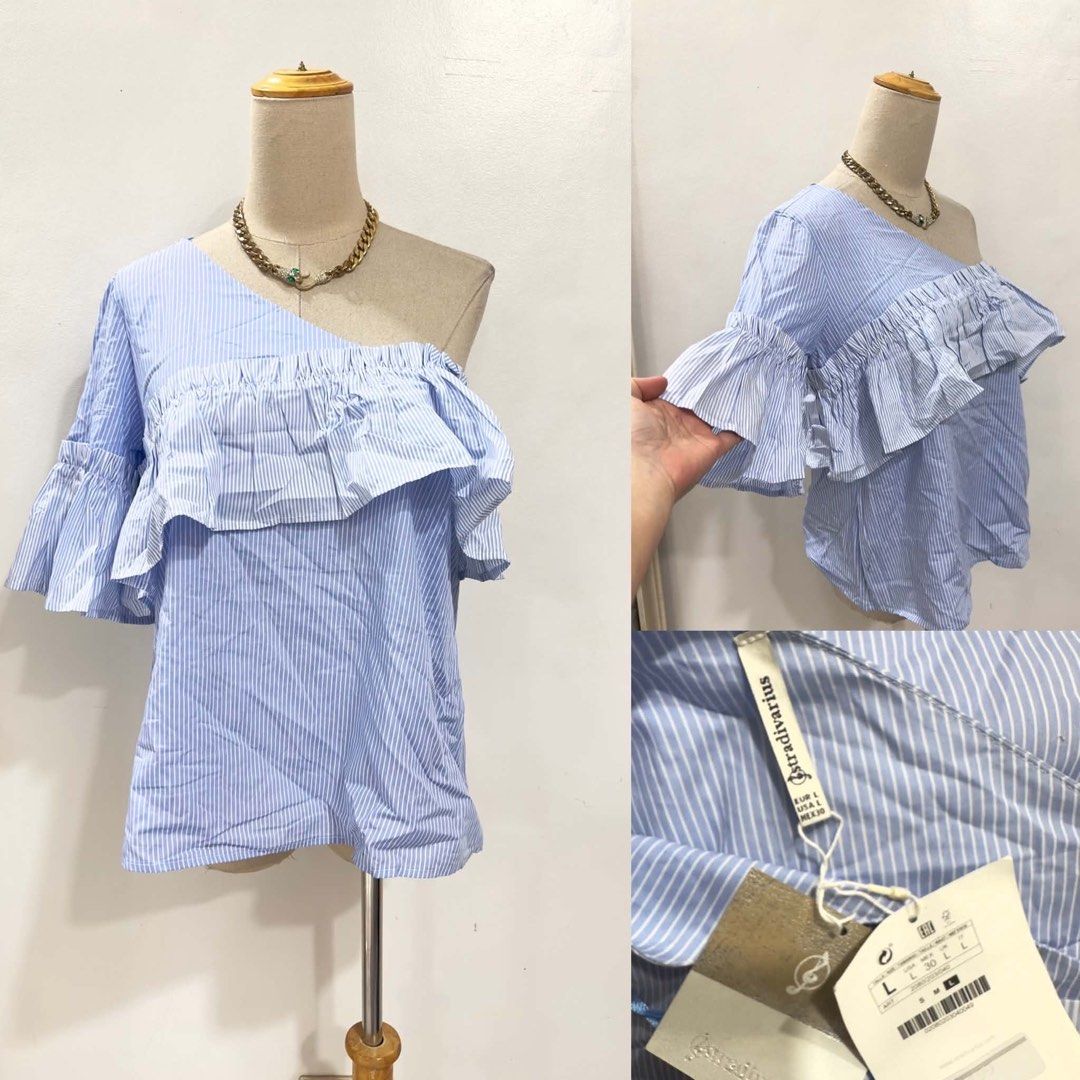 Stradivarius Blue Striped One Shoulder Ruffle Top (Category: Sleeveless) located in Bacolod City. Submitted by bhabissagal-05763 (Listing ID 1462190397, Image 1). Description: - Cute blue and white striped top - Brand: Stradivarius - Design: One-shoulder with ruffled overlay - Sleeves: Bell sleeves - Size: L - Versatile: Great for night outs or casual days - Easy to style with jeans or shorts.