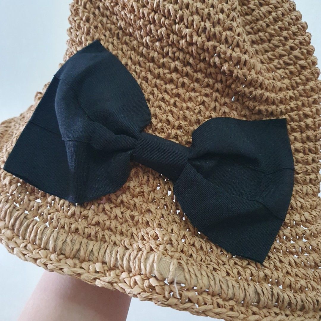 Straw Hat with Black Bow Detail (Category: Hats & Beanies) located in Paranaque City. Submitted by cobien (Listing ID 1462165617, Image 3). Description: - Cute straw hat with a large black bow - Breathable woven material - Comfortable inner band - Perfect for sunny days, beach trips, or casual wear - Adds a stylish touch to any outfit - inside rim is a bit dirty.