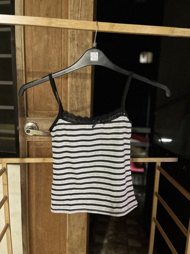 Striped Lace Trim Tank Top (Category: Sleeveless) located in Caloocan City. Submitted by decluttering.101_ (Listing ID 1462123457, Image 1). Description: - Classic black and white stripes - Elegant lace trim along the neckline - Adjustable spaghetti straps for a perfect fit - Versatile for layering or standalone wear - Comfortable and casual style.