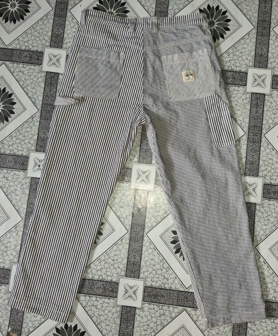 Stussy Patchwork Striped Carpenter Pants (Category: Jeans) located in Ilagan. Submitted by culalabejen05 (Listing ID 1462125965, Image 1). Description: - Stussy Carpenter Pants - Unique patchwork design - Classic navy and white pinstripe pattern - Multiple practical pockets - Relaxed fit for everyday comfort - Size: 32 Best fit 34 - Made in China.