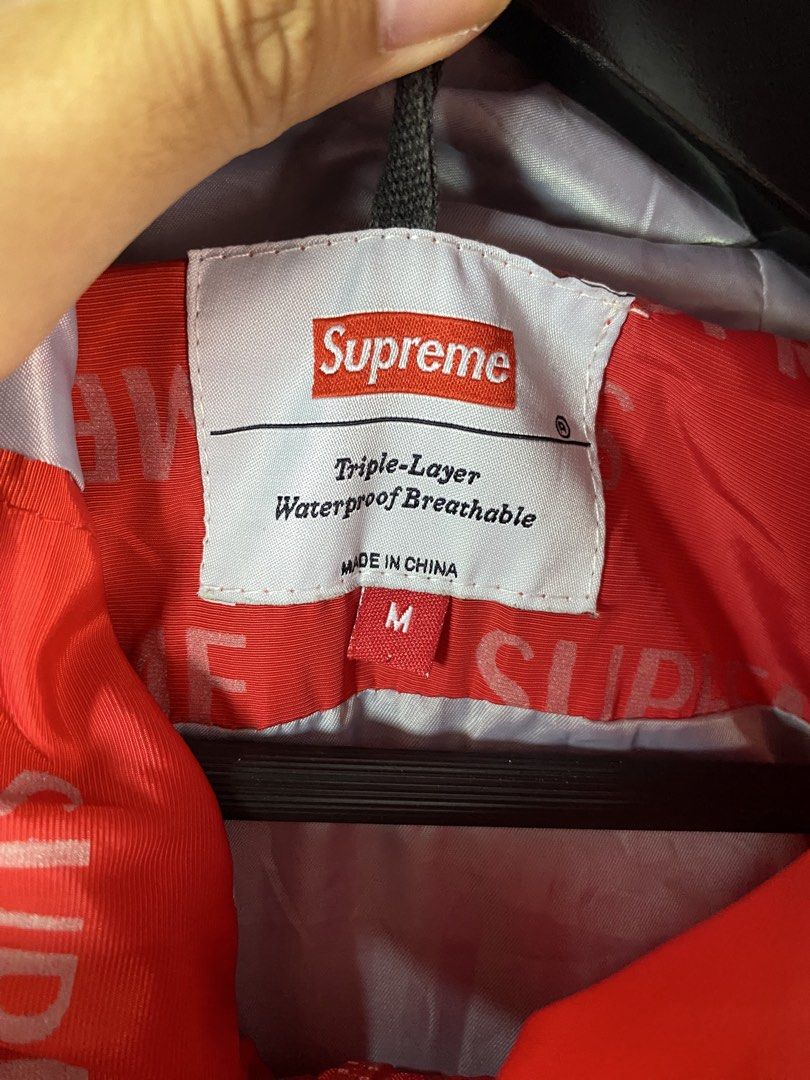 Supreme Triple-Layer Waterproof Breathable Jacket Size M (Category: Coats, Jackets and Outerwear) located in Manila. Submitted by declutterpromax (Listing ID 1462110556, Image 2). Description: - Supreme Triple-Layer Jacket - Waterproof & Breathable - All-over Red Supreme Logo Print - Size: Medium (M) - Made in China - Ideal for Rainy Days & Outdoor Activities.