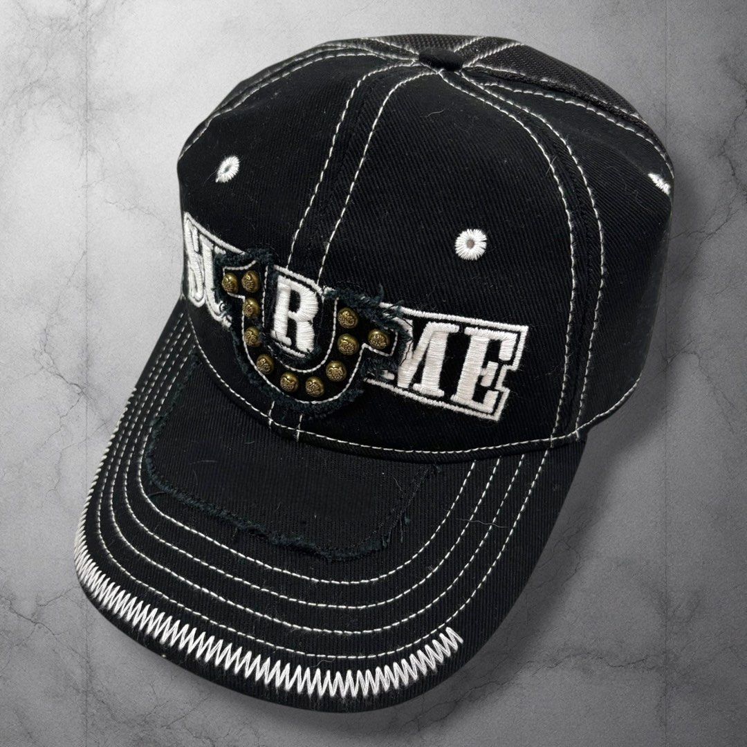 Supreme x True religion Cap Black White Stitching Studs (Category: Caps & Hats) located in Cavite. Submitted by itsayaaa (Listing ID 1462094232, Image 1). Description: - Black trucker cap with white contrast stitching - Features a 'Supreme' logo with metal stud accents - Mesh back for enhanced breathability - Adjustable strap for a customized fit - Interior lining with a red graphic print Supreme x True religion .