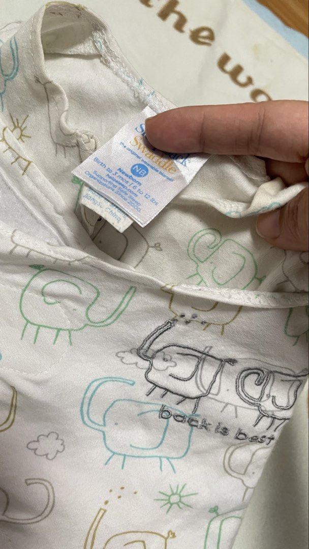 Swaddle Designs "Back is Best" Baby Swaddle (Category: Babies & Kids Fashion) located in San Jose del Monte. Submitted by momma_buys (Listing ID 1462114146, Image 2). Description: - Swaddle Designs "Back is Best" swaddle - Adorable elephant print - Size: NB (Newborn), fits 6-12 lbs - Material: 100% Cotton - Features: Zipper closure for easy diaper changes - Benefit: Keeps your baby snug and secure.