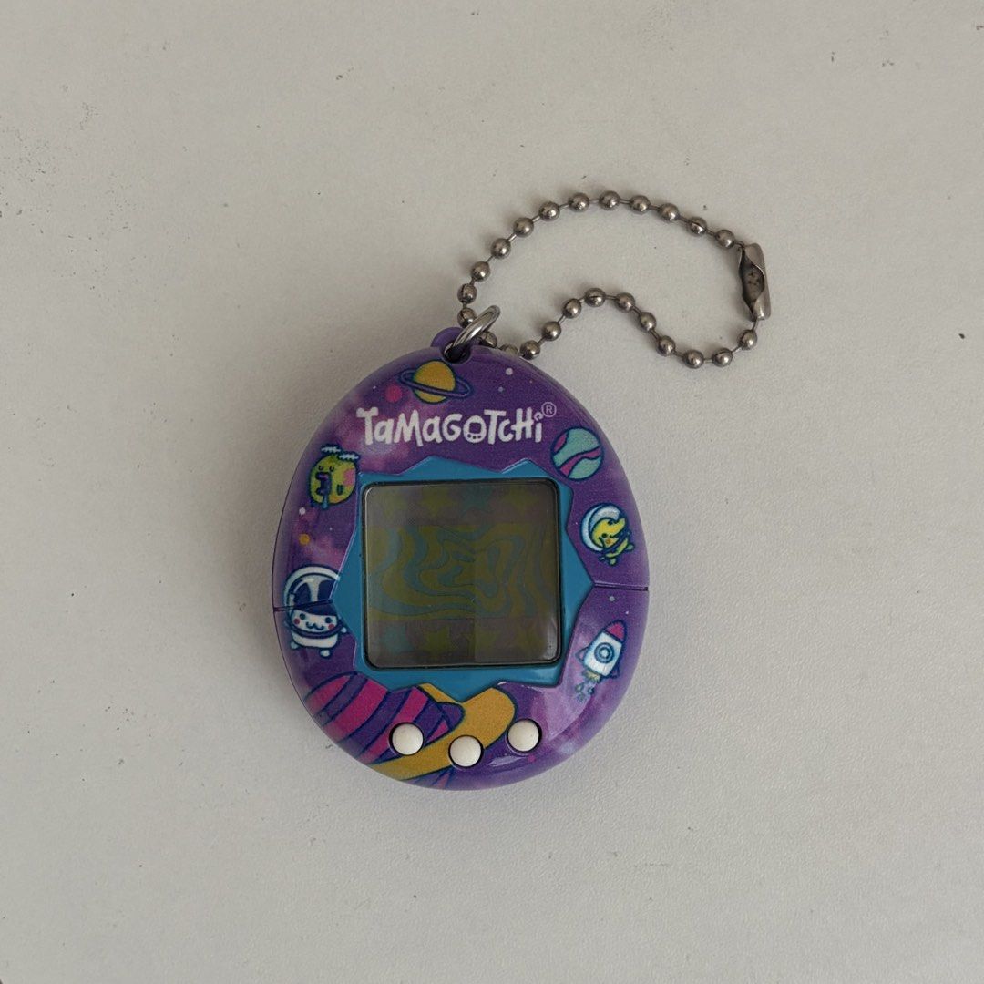 Tamagotchi Gen 2 Purple Planets and Space (Category: Interactive Toys) located in Manila. Submitted by mimitchii (Listing ID 1462078156, Image 1). Description: Tamagotchi Gen 2 Purple Planets and Space - working! no issues :) - rfs: decluttering 📍Pulilan, Bulacan.