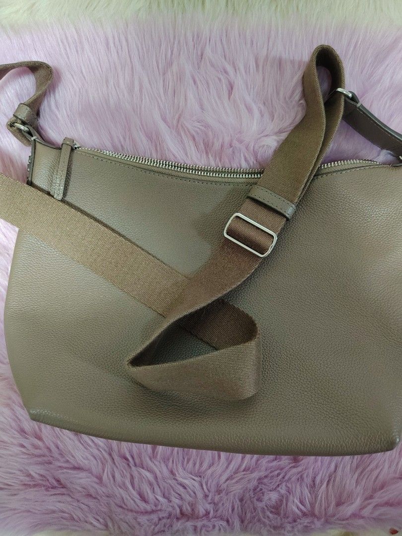Taupe Leather Crossbody Bag with Adjustable Strap (Category: Cross-body Bags) located in Valenzuela. Submitted by glitter_preloved (Listing ID 1462124244, Image 2). Description: - Chic taupe crossbody bag - Genuine pebbled leather - Spacious main compartment with secure zip closure - Comfortable, adjustable fabric strap - Ideal for daily use - Clean interior.