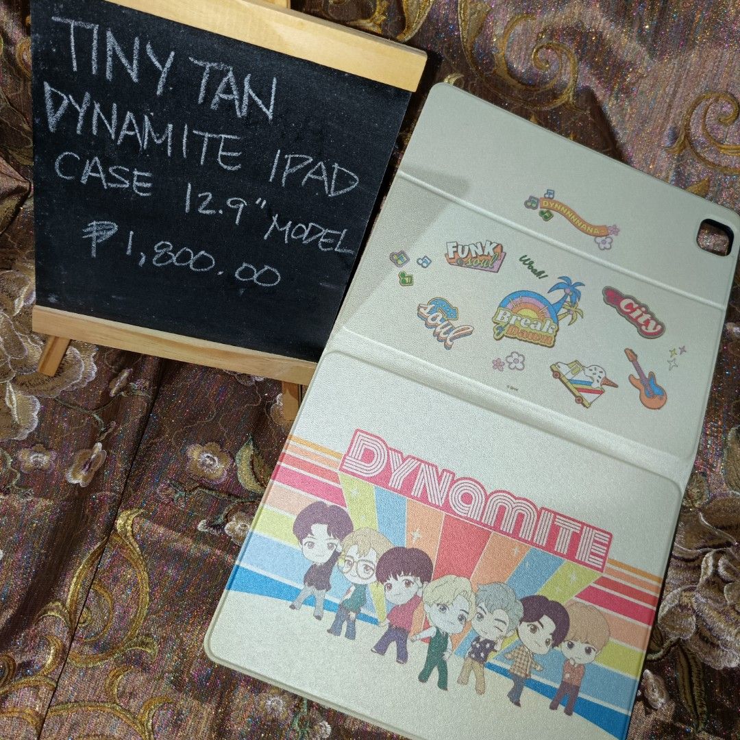 Tiny Tan Dynamite iPad Case for 12.9" Model (Category: Cases & Sleeves) located in Manila. Submitted by cypherchepark (Listing ID 1462232492, Image 1). Description: From 1,800.00 SALE to 1,400.00 only 💜 - Protect your 12.9" iPad with this adorable Tiny Tan Dynamite case. - Features all BTS members dressed in their iconic Dynamite outfits. - Includes a convenient stand function for hands-free viewing. - A must-have for any dedicated ARMY! - Price