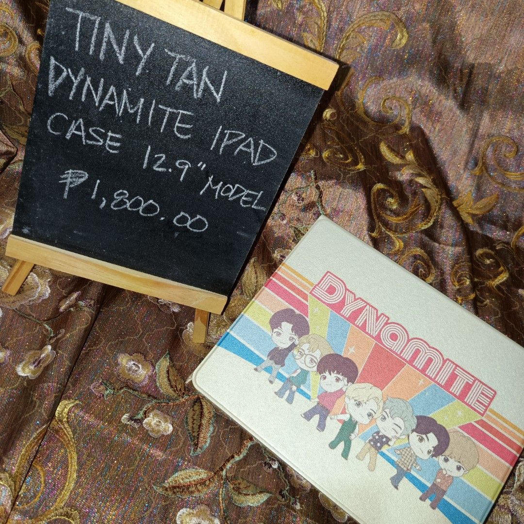 Tiny Tan Dynamite iPad Case for 12.9" Model (Category: Cases & Sleeves) located in Manila. Submitted by cypherchepark (Listing ID 1462232492, Image 3). Description: From 1,800.00 SALE to 1,400.00 only 💜 - Protect your 12.9" iPad with this adorable Tiny Tan Dynamite case. - Features all BTS members dressed in their iconic Dynamite outfits. - Includes a convenient stand function for hands-free viewing. - A must-have for any dedicated ARMY! - Price
